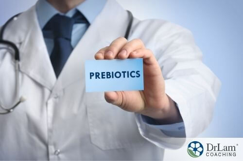 An image of a person holding up a paper that says prebiotics