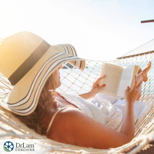 woman on laying on hammock enjoying the benefits of reading