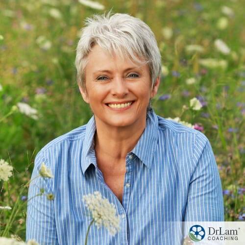 woman smiling in a field of flowers with delay menopause