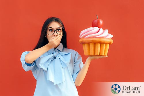 woman holding giant cupcake showing that you should go through juice fasting