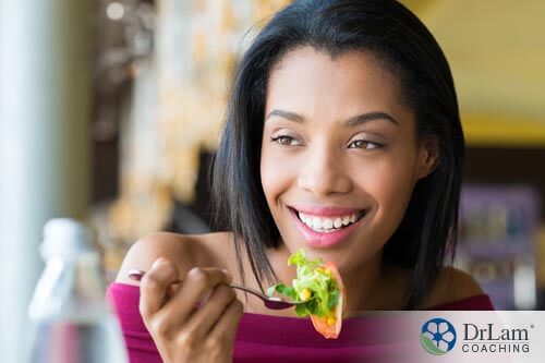 A young healthy woman eating a salad and enjoying her gluten-free diet