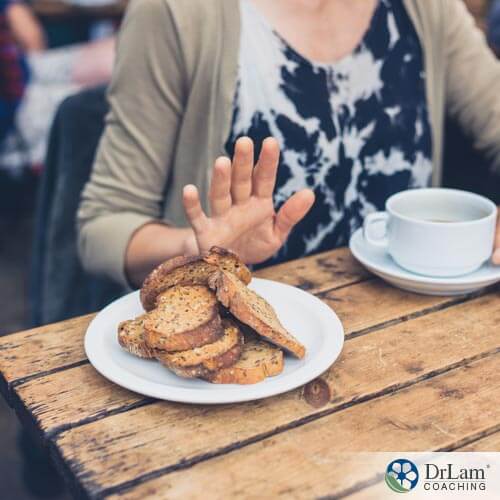 Person turning away bread for gluten-free diet