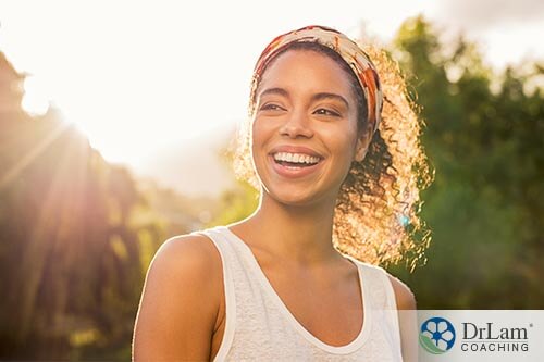 smiling woman experiencing health benefits of the sun
