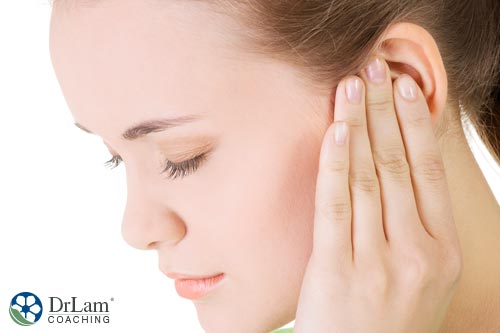 woman holding ear may have Meniere's Disease