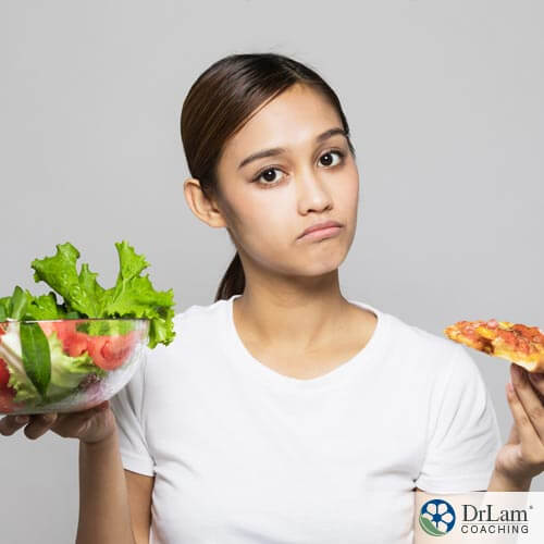 An image of a woman holding a bowl of salad and a slice of pizza deciding which to eat