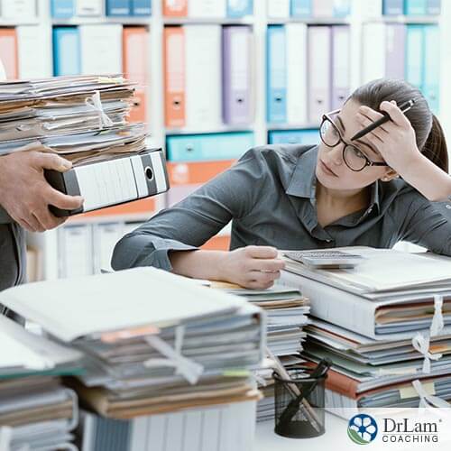 woman with a lot of paperwork and workplace stress