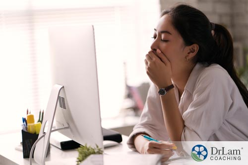 Young woman very tired and yawning from working too hard