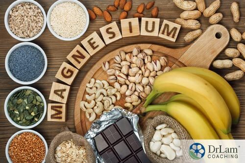Nuts, bananas, chocolate all on a board with benefits of magnesium spelled out