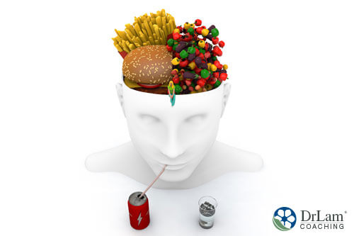 An image of a white porcelain bowl in the shape of a human head holding junk food