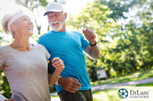 An image of an older couple jogging together smiling