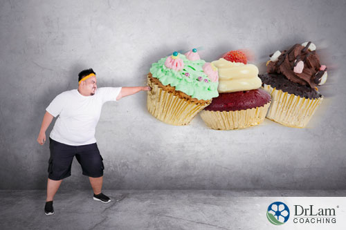 An image of an overweight man punching away 3 cupcakes