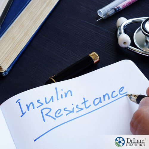 An image of someone writing insulin resistance in blue ink on a notepad