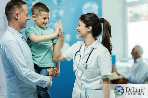 An image of a young boy giving a doctor a high five