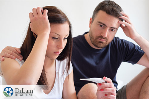 An image of a stressed-out couple looking at a pregnancy test