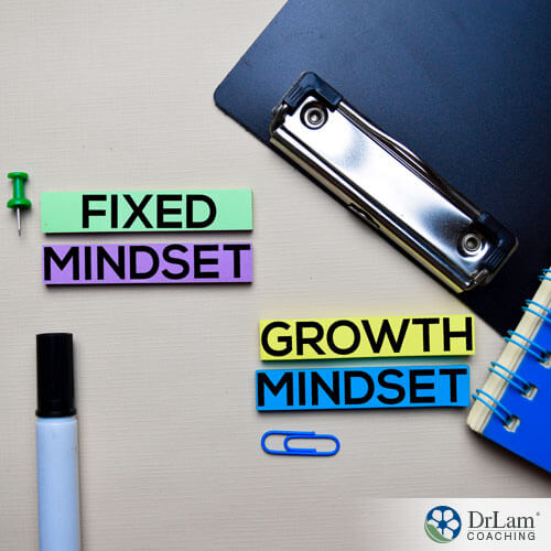 An image of a desktop with colored notes saying fixed mindset and growth mindset