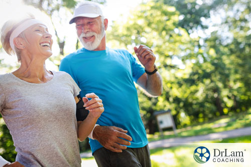 An image of an older couple smiling as they jog together