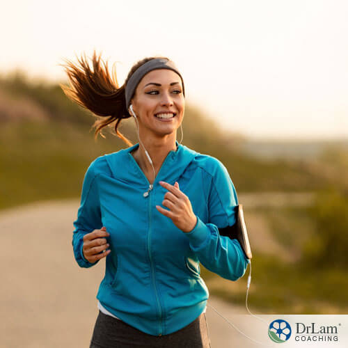 An image of a smiling woman out jogging