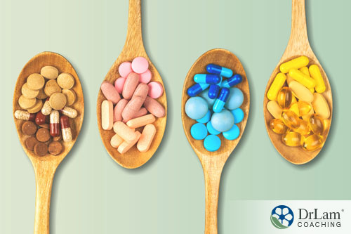 An image of four wooden spoons with different colored supplements