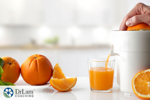 An image of someone making orange juice