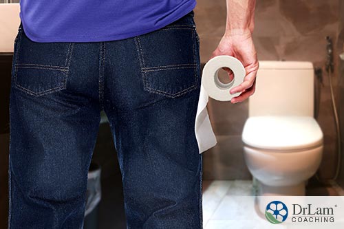 man with toilet paper preparing to use bathroom may benefit from vitamin d and ibs