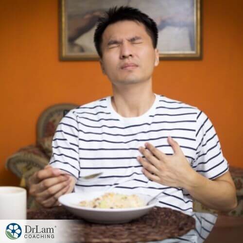 An image of a person in the middle of having a meal and looking like he is in pain