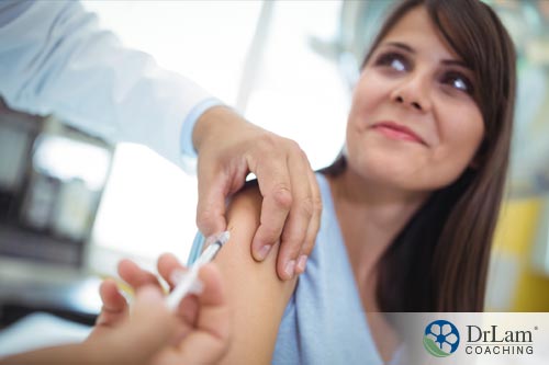 An adult woman getting flu shot, one of most common vaccinations