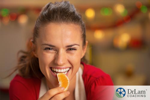 A woman eating orange to remedy bad breath