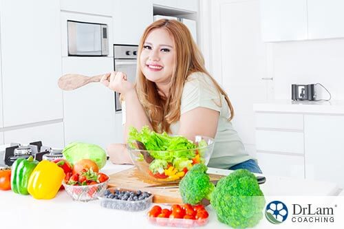 a girl preparing salad for obesity and gut bacteria