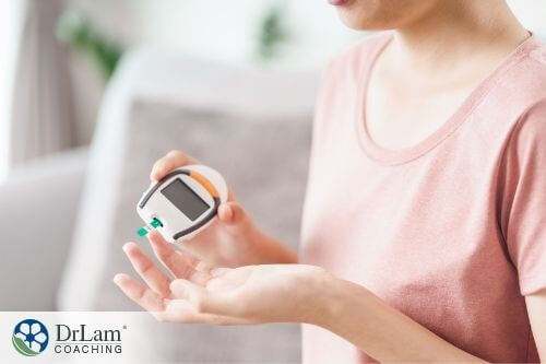 An image of a woman measuring her blood glucose level