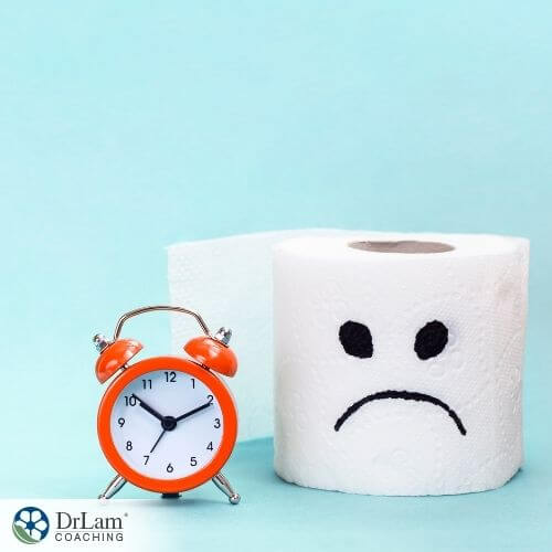 An image of an alarm clock and roll of toilet paper