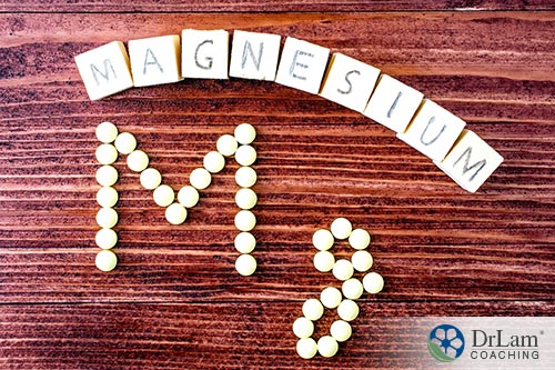 An image of magnisuem spelled out with scrabble letters above as well as dots below on a table