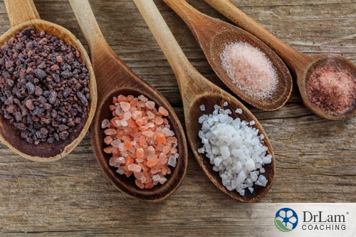 An image of five wooden spoons containing different types of salt which will be used to sedate the cravings from adrenal exhaustion symptoms