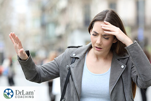 Image of a woman having headache and experiencing dizziness