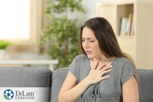 An image of a woman holing her chest in pain