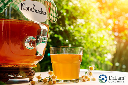 an image of a jug and glass of kombucha