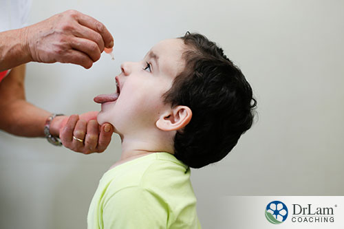 child is happily taking his medicine or supplement given by a doctor