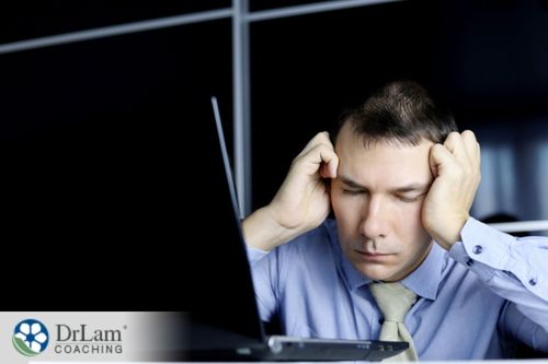 An image of a man falling asleep at his computer