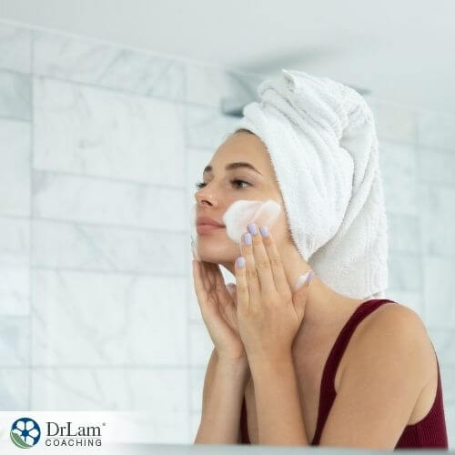 An image of a woman washing her face