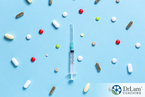 An image of a syringe surrounded by different pills