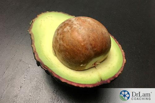 An image of a halved avocado with a large pit