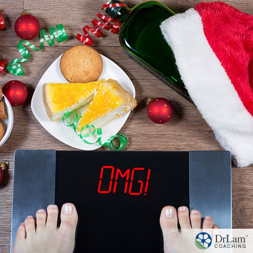 An image of a scale reading OMG! With holiday treats all around on the floor