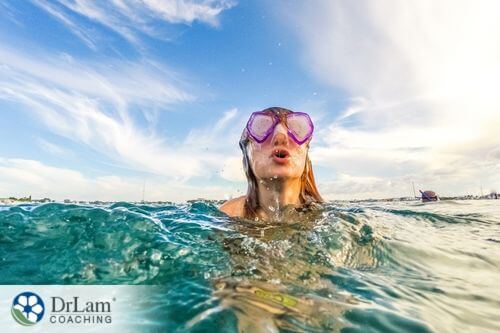 An image of a woman swimming with goggles