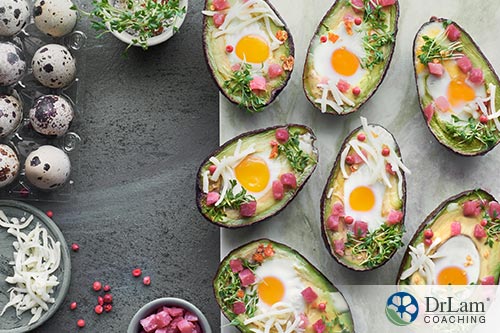 An image of baked avocados with cheese, quail eggs and ham