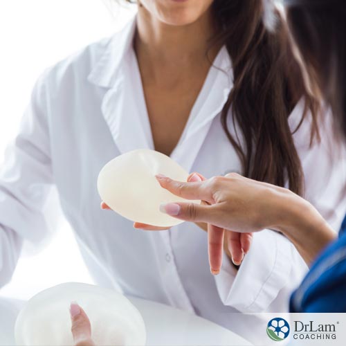 An image of a woman looking at breast implant choices and thinking about the possibility of getting breast implant illness