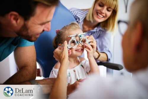 An image of a young girl and her parents at the optometrist