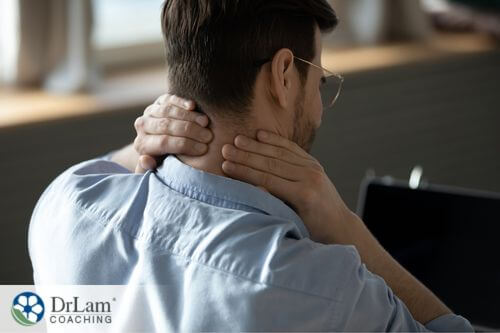 An image of a man rubbing the back of his neck
