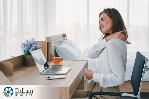 An image of a woman massaging her shoulder