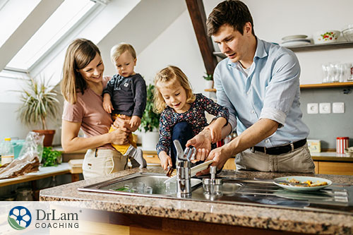An image of a family washing dishes together