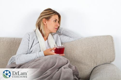 An image of a woman on the couch with a cup of tea