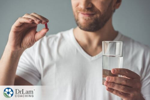 An image of a man taking a supplement